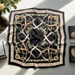 Elegant black square scarf with gold chain and belt print, versatile fashion accessory.