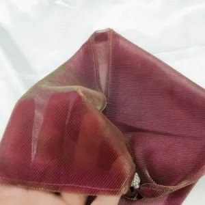 Detail shot of shimmering triangle scarf, wine red mesh fabric with magnetic buckle clasp.