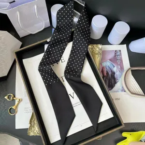 Black and white polka dot twilly scarf for handbag handle or hair band, elegant ribbon streamer accessory.