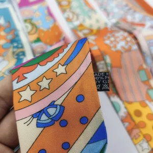 Luxury silk twilly scarf for handbag handle decoration, vibrant multi-color print ribbon.