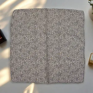 Detail view of vintage printed square scarf, elegant neck accessory for women, close-up.
