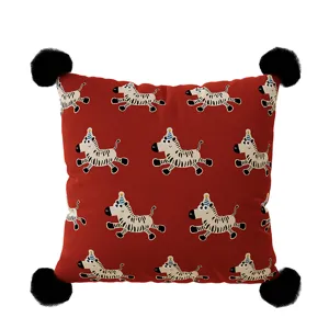 Festive red square throw pillowcase featuring cute cartoon zebra design with black pompoms.