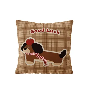 Close-up detail of the brown plaid throw pillow featuring a cute cartoon puppy design.