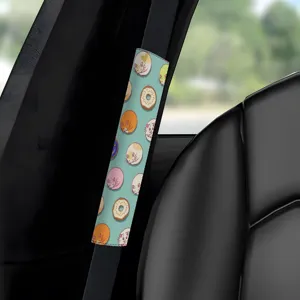 Car seatbelt cover with cute cat and donut pattern, comfortable shoulder pad, interior decor.