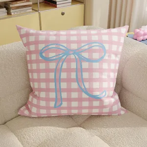Pink and white checkered throw pillow featuring a cute blue bow detail for cozy room decor.