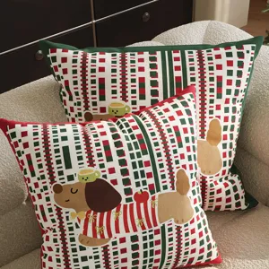 Detailed view of Christmas red green plaid decorative throw pillow featuring cute dachshund cartoon print.
