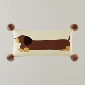Cute dachshund dog lumbar pillow detail, soft plush fabric with fluffy corner pom-poms.
