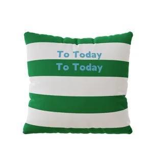 Modern green and white striped throw pillow with text print for cozy home sofa decor.