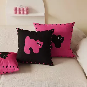 Close-up of black pink cat pillows with polka dots, perfect for vibrant sofa and home decor.