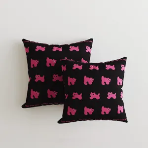 Detailed view of the black and pink cat print throw pillow, showcasing the playful design.