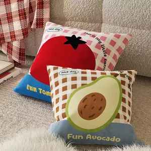 Detailed view of cute fruit pattern throw pillows with tomato and avocado designs on cozy sofa.