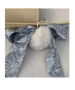 Handbag pendant detail, blue paisley ribbon bow and white plush pom-pom decoration.