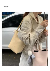 Minimalist leather bucket bag women 2026 new versatile solid color shoulder handbag style.