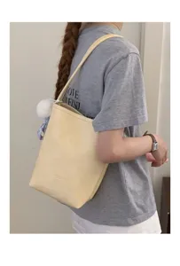 Minimalist yellow leather bucket bag shoulder bag detail showing stylish daily wear and cute charm.