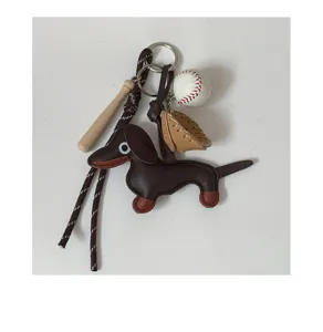 Cute leather dachshund keychain with mini baseball bat and glove bag charm accessory.
