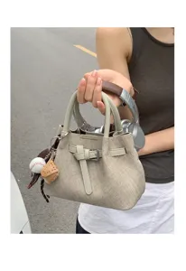 Minimalist canvas tote handbag for women, casual small top handle bag with charm.