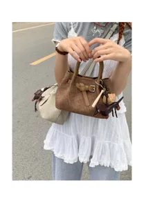 Chic mini tote bag with stylish animal charms, perfect for daily casual fashion wear.