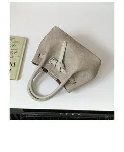 Minimalist textured handbag for women, chic top handle tote bag with stylish buckle detail.