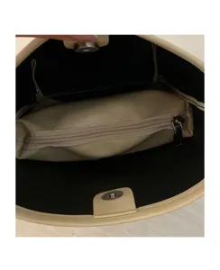 Interior detail of women beige bucket bag showing zipper pocket and magnetic snap closure.
