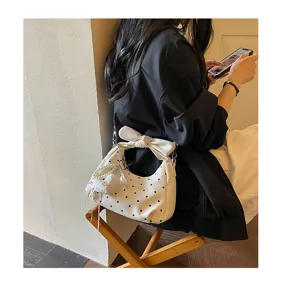 White polka dot hobo shoulder bag close detail showing stylish bow and pearl pendant.