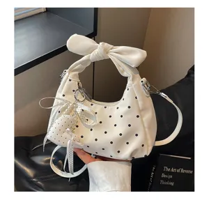 Chic white polka dot hobo handbag with cute bow handle, stylish crescent crossbody shoulder bag.