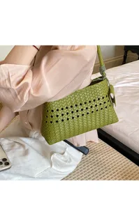 Green woven leather shoulder bag with chic hollow design, perfect for stylish daily commuting.