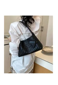 Detailed view of a black woven leather underarm shoulder bag showing texture and craftsmanship.