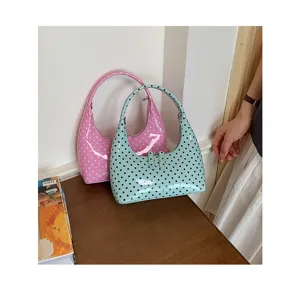 Chic patent leather hobo handbag featuring a stylish polka dot print, perfect for daily casual wear.