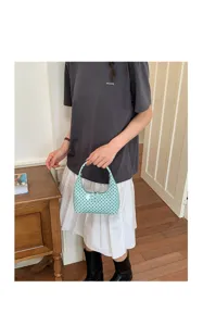Detail shot of a chic mint green polka dot hobo handbag, perfect for stylish everyday wear.