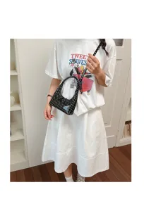 Stylish black and white polka dot crescent shoulder bag, chic minimal handbag for women.