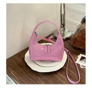 Pink polka dot hobo bag detail, glossy finish crescent handbag with stylish silver hardware and strap.