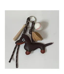 Detailed view of the cute leather dachshund bag charm featuring mini baseball and bat.