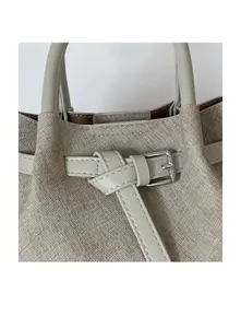 Minimalist textured small tote bag with metal buckle belt detail for daily casual wear.