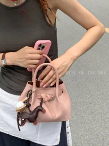 Chic pink handbag for women, stylish tote bag with metal buckle and cute charms daily use.