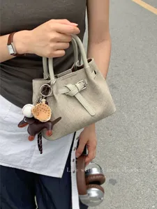 Minimalist textured mini tote bag for women, stylish canvas handbag with cute charms.
