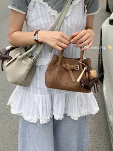 Chic minimalist crossbody handbag for women, versatile small tote bag with cute charms.