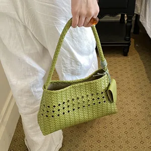 Green woven leather handbag for women, chic hollow underarm shoulder bag, stylish daily commuting tote.