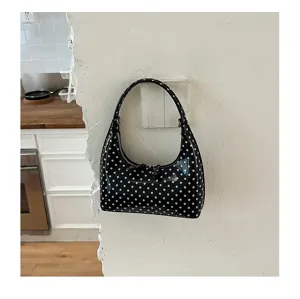 Chic black and white polka dot hobo shoulder bag, minimalist crescent handbag for women.