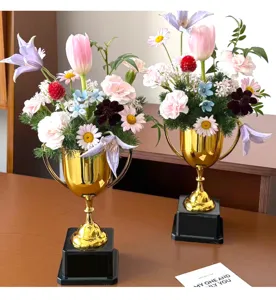 Gold trophy floral arrangement detail showing vibrant DIY flower materials and decorative pieces.