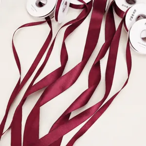 Burgundy satin ribbon rolls for flower bouquet wrapping, gift packaging, and craft DIY.