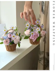 Close-up detail of a handmade woven flower basket filled with pink roses and purple daisies.