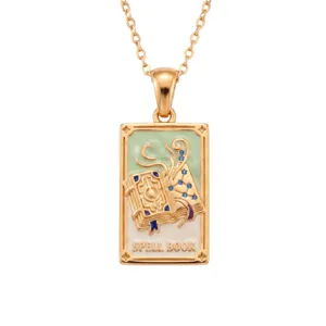 Gold tarot card pendant necklace featuring enamel spell book design with blue gems for daily wear.