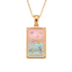 Close-up detail of the gold tarot card macaron necklace with colorful enamel and gemstones.