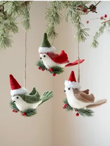 Felt Christmas bird hanging ornaments with Santa hats and pine branches for tree decor.
