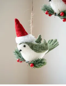 Christmas felt bird hanging ornament with Santa hat, pine needles, and red berries decor.