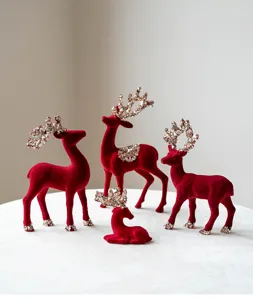 Red flocked Christmas reindeer figurine set with glitter sequins for holiday desktop decor detail.