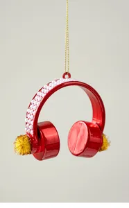 Close-up detail of red Christmas headphone ornament with white pearls and gold accents.