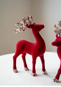 Christmas red flocked reindeer figurine with sparkling sequin antlers, festive table decor.