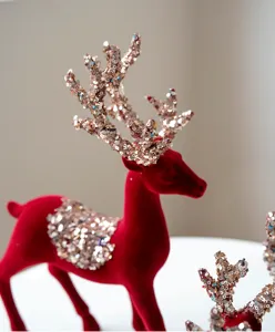 Detailed view of a red flocked Christmas reindeer figurine with sparkling sequin antlers.
