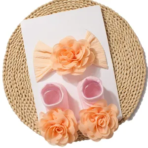 Cute baby headband and socks set with large peach fabric flowers for infant daily wear.